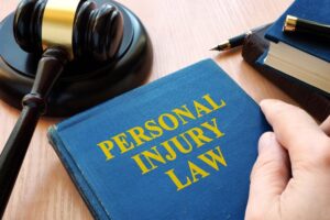 A gavel rests on a desk beside legal documents, symbolizing personal injury law. The scene conveys justice and legal proceedings for injury cases.