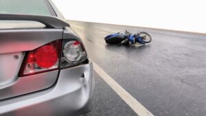 A motorcycle rear-ended your car, causing the bumper to crack and the rear light to break.