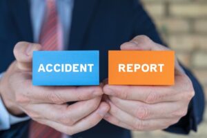 Man holding colorful blocks sees inscription: ACCIDENT REPORT.