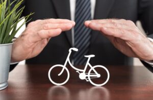 Lawyer protecting a bicycle with his hands