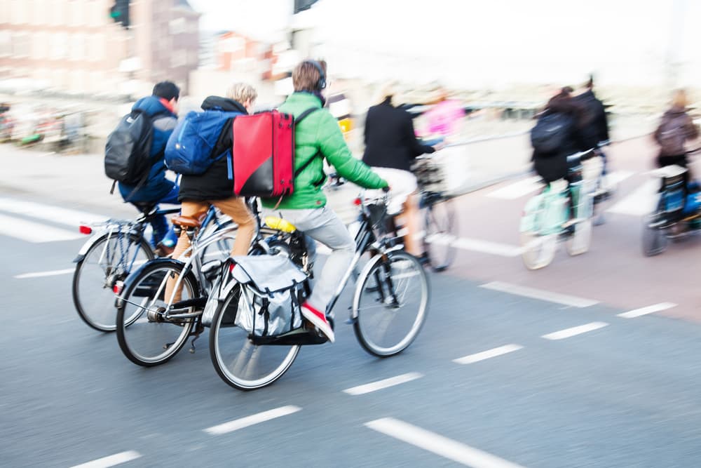 Bicycle riders in the city traffic in motion blur