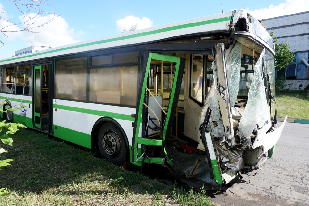 Damaged bus parked after an accident, symbolizing careless driving and vehicle collision aftermath