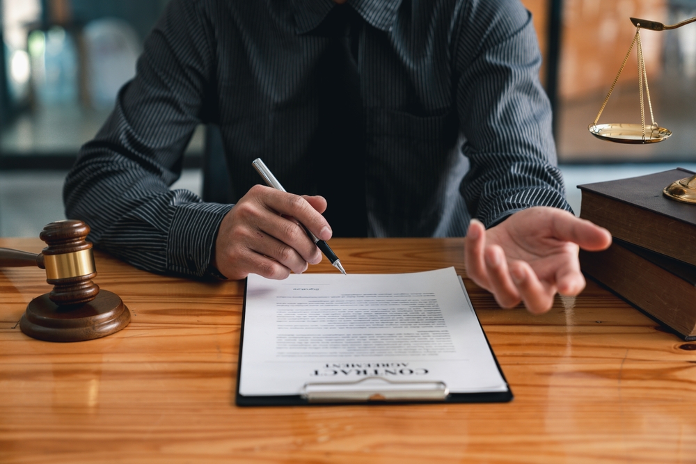 Lawyer or judge providing legal advice to businessmen, explaining consultation terms and conditions before signing a contract at a law firm