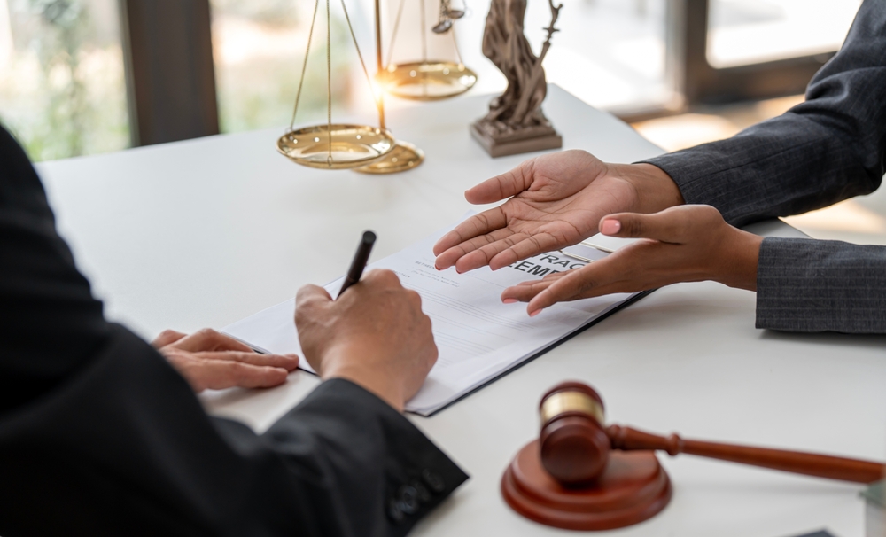 Businessperson signing an agreement in a contract, symbolizing legal commitment and formal business dealings