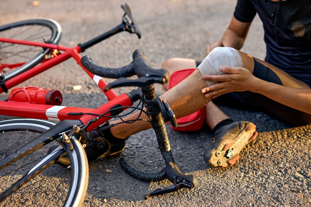Injured cyclist receiving first aid after a bicycle accident in Redding 